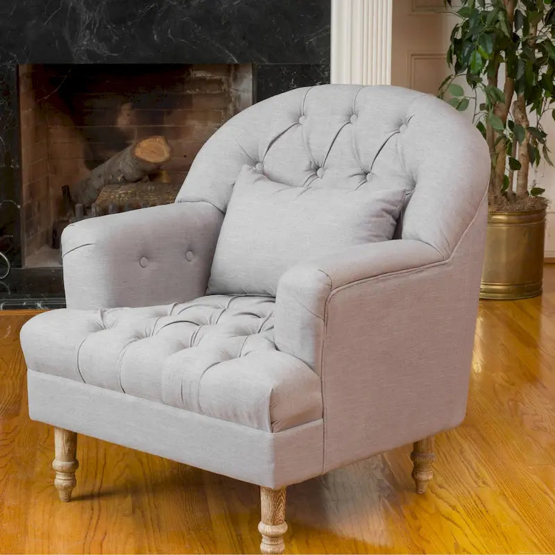Gepolsterter Sessel mit Knopfheftung, Tonnenrücken und gedrechselten Holzbeinen