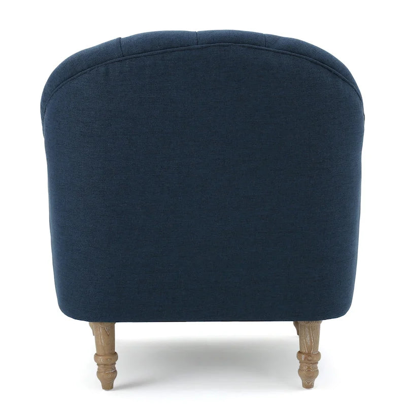 Poltrona imbottita trapuntata con schienale a botte e gambe in legno tornito